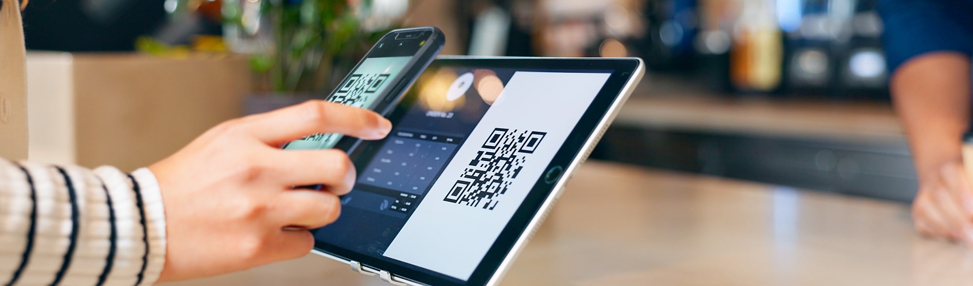 Hands, phone and qr code in coffee shop, payment and fintech app with pos, deal and services with scanning in store. People, smartphone and machine for point of sale, banking and barcode in cafeteria